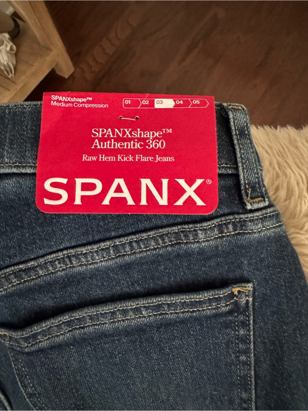 SPANX Raw Hem Kick Flare Jeans in Dark Blue Denim